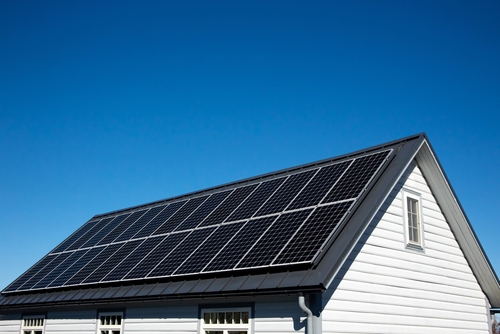 A photo of a residential black solar panel installation setup on a house's roof